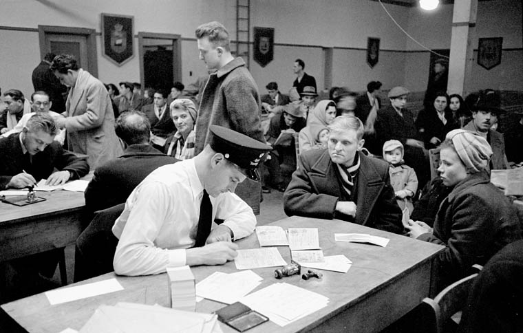 New arrivals being examined in the Immigration Examination Hall at Pier 21, Halifax, the kind of arrival that preceded many a naturalized Canadian ancestor